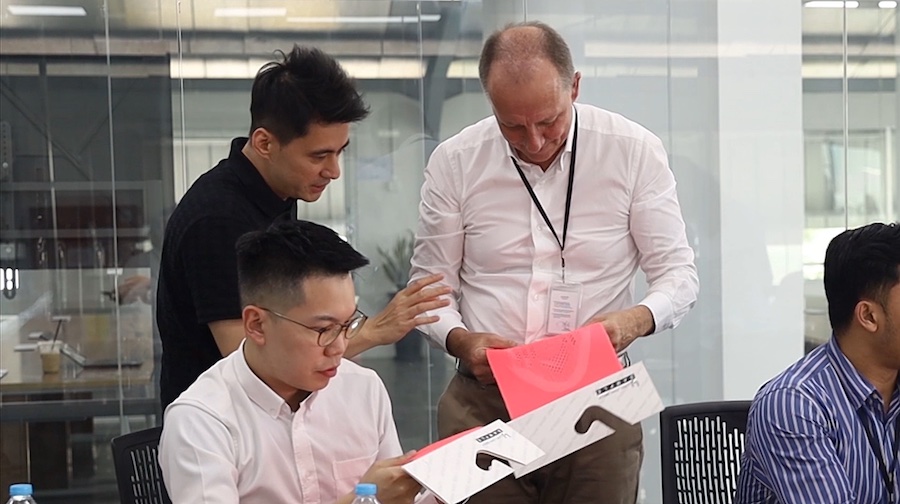 Karl Josef Mayer, grandson of the founder of KARL MAYER, in conversation with Kevin Wen (back left), son of the founder and Chairman of Long John, Jeff Wen, about the latest textile innovations © 2026 KARL MAYER 