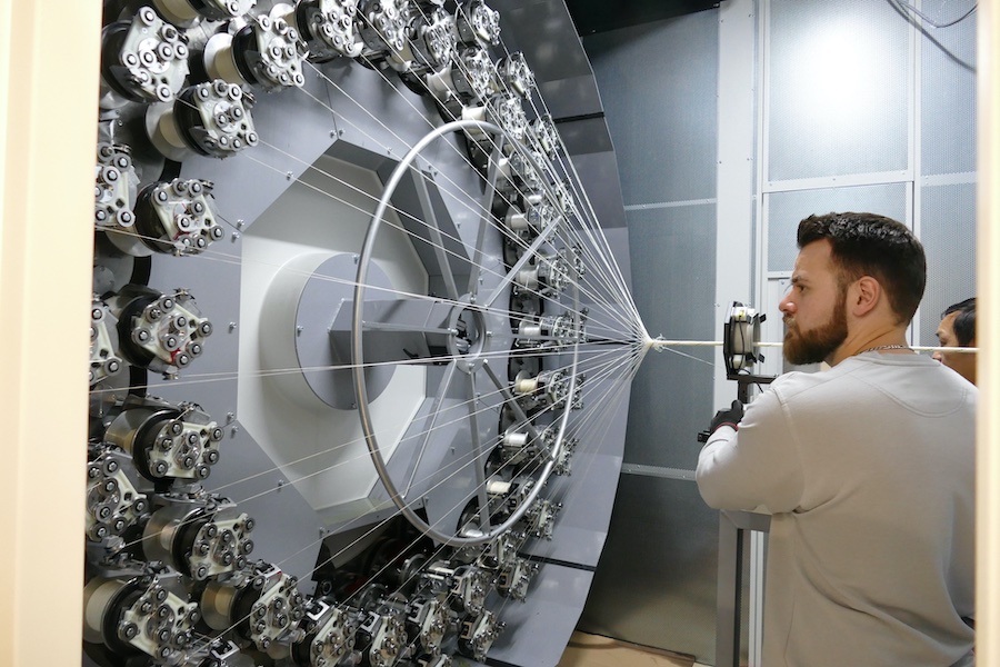 Technician at a braiding machine © 2025 Mayer & Cie.