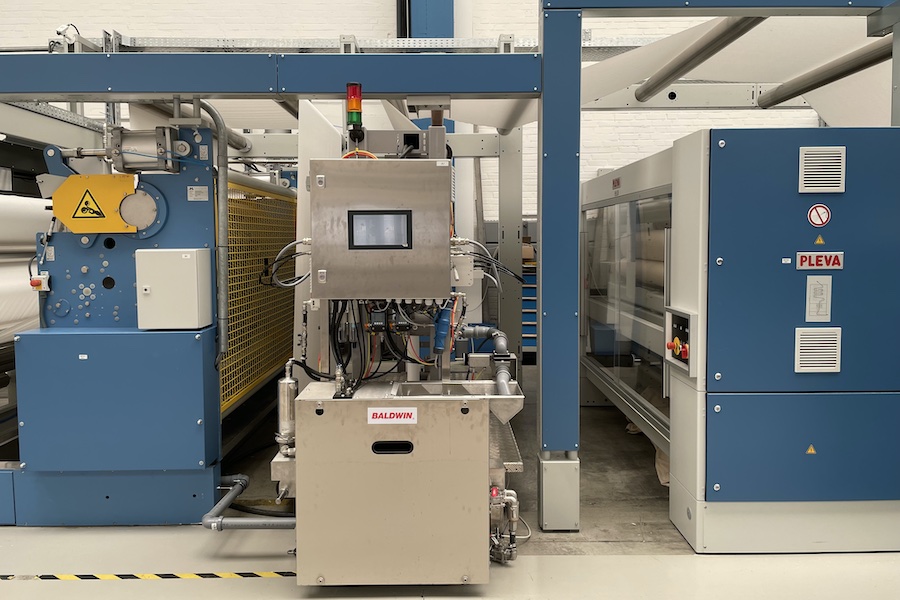 The Baldwin TexCoat™ G4 spray unit integrated into a Montex stenter at the Monforts ATC in Germany. © 2025 Monforts