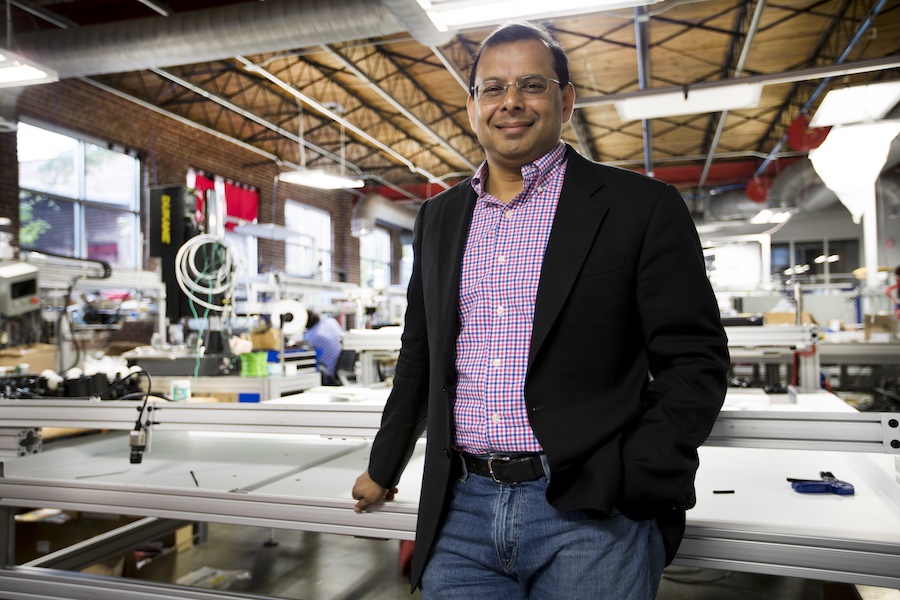 Palaniswamy “Raj” Rajan, Chairman and CEO of Softwear Automation in front of SEWBOTs © 2025 Softwear Automation